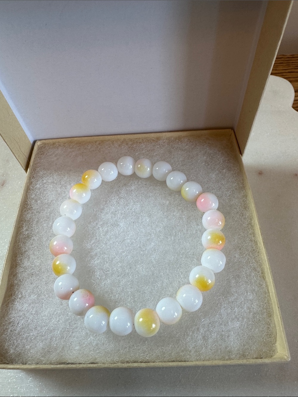 Handcrafted White Beaded Bracelet with Pink and Yellow Accents